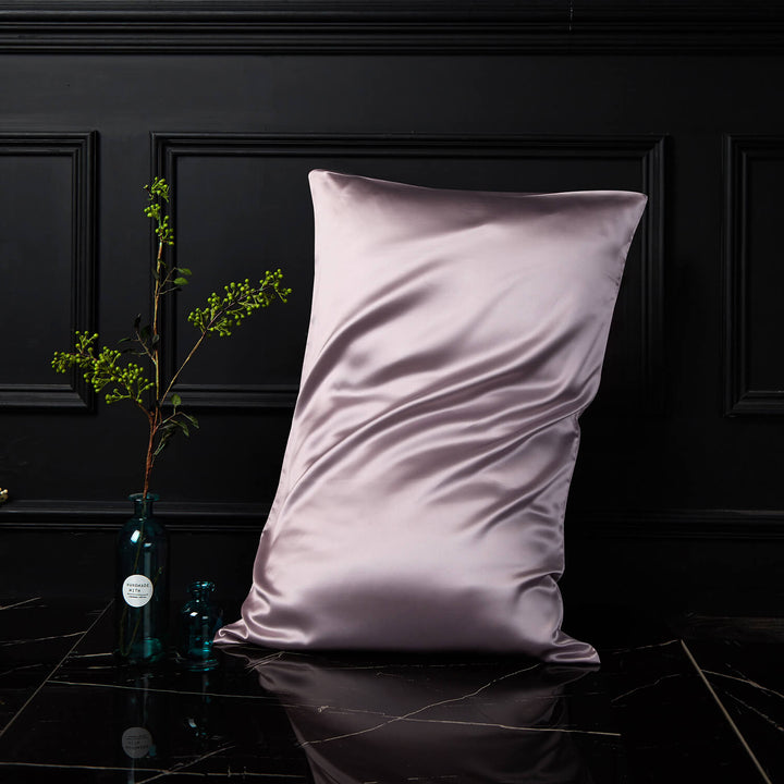 Lilac silk pillowcase displayed upright against a dark background