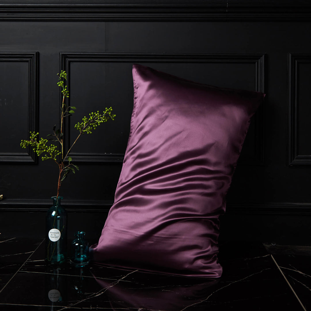 Purple silk pillowcase displayed upright against a dark background