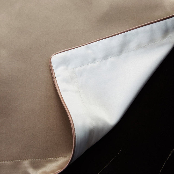Pillowcase corner showing champagne silk front and white lyocell reverse
