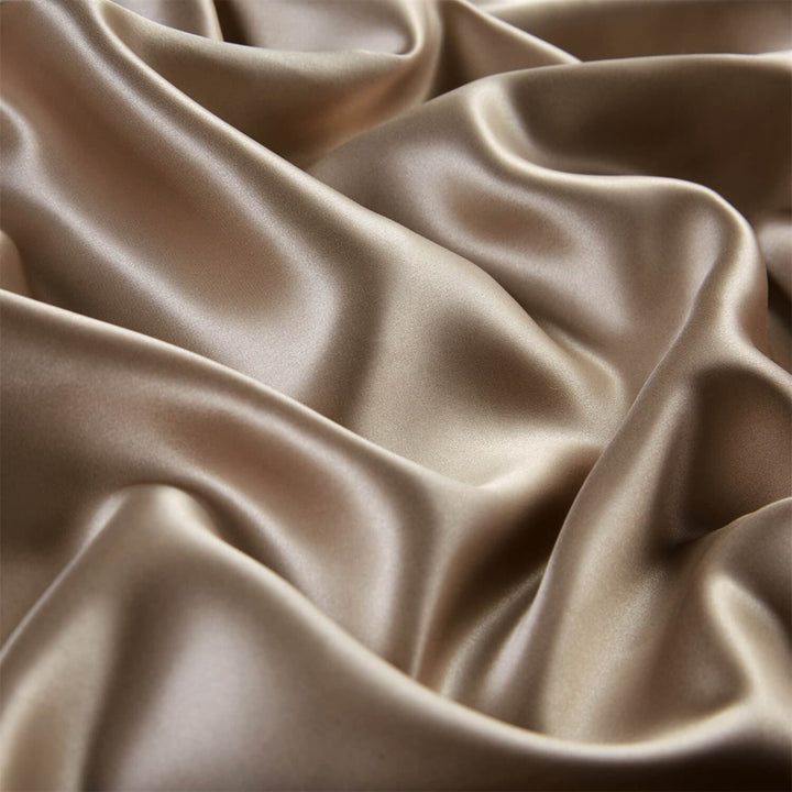 Close-up of softly folded champagne silk fabric