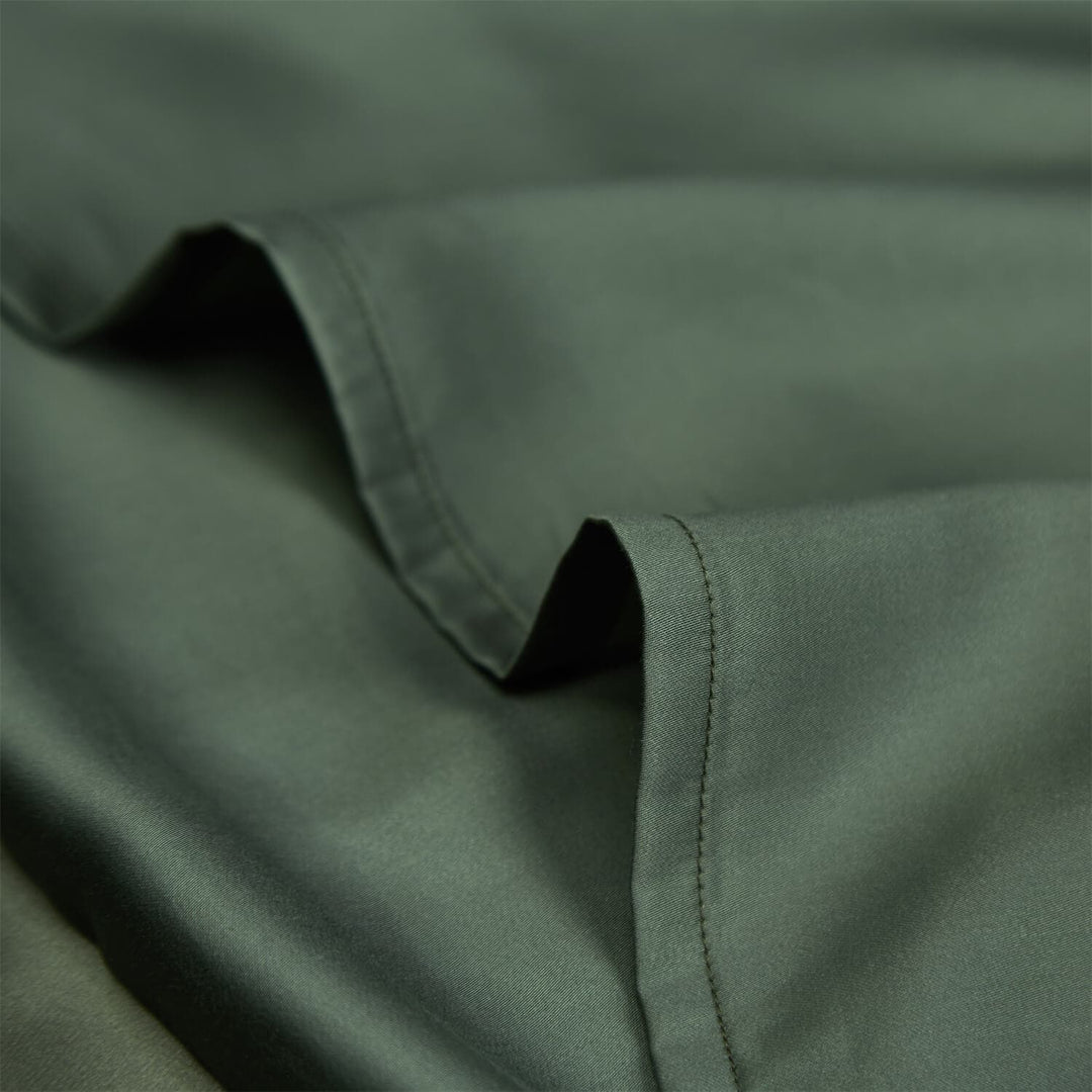 Close-up of green pillowcase fabric and stitched edge