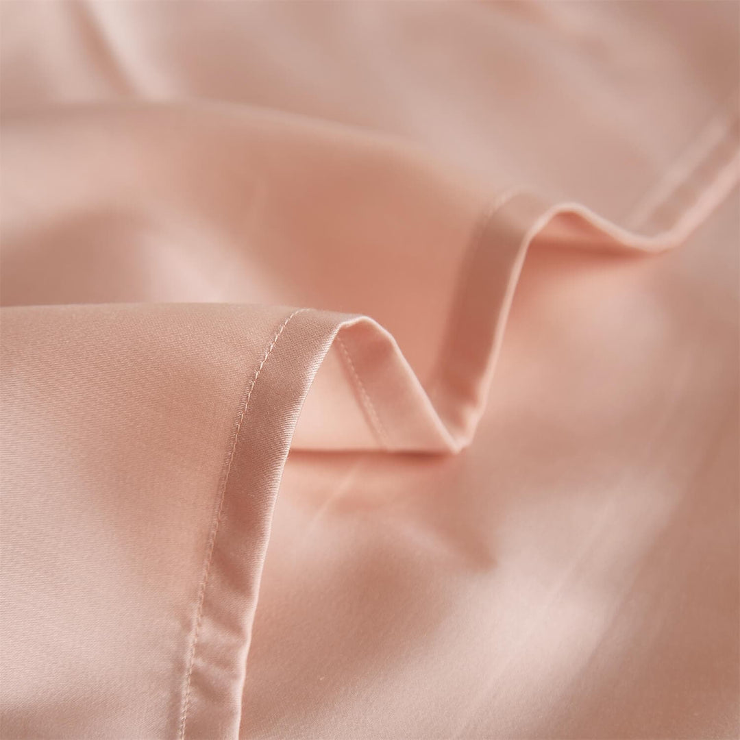 Close-up of pink pillowcase fabric and stitched edge